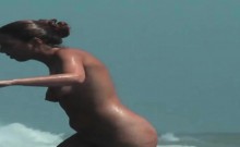 Sexy toned body walking naked on a crowded beach