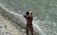 Voyeur video of sexy brunette nude hottie at the beach