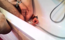 Bi-guy using shower head, squirting water, enema